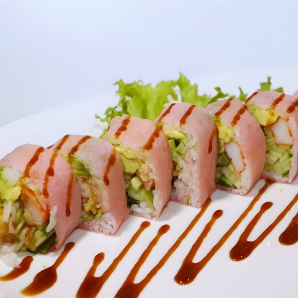 Asuka Japanese Cuisine's pink sushi rolls with avocado, cucumber, and shrimp, drizzled with sauce.